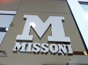 Silver capital serif M with the name Missoni underneath