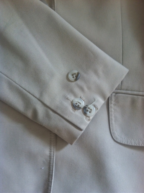 close up of a button that needs to be sewn on