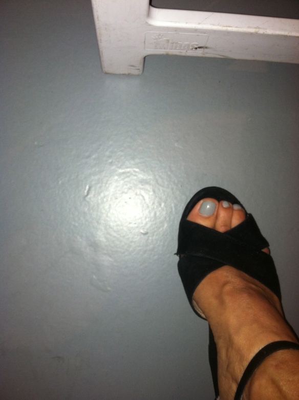 Jill's foot in a black suede open toed shoe